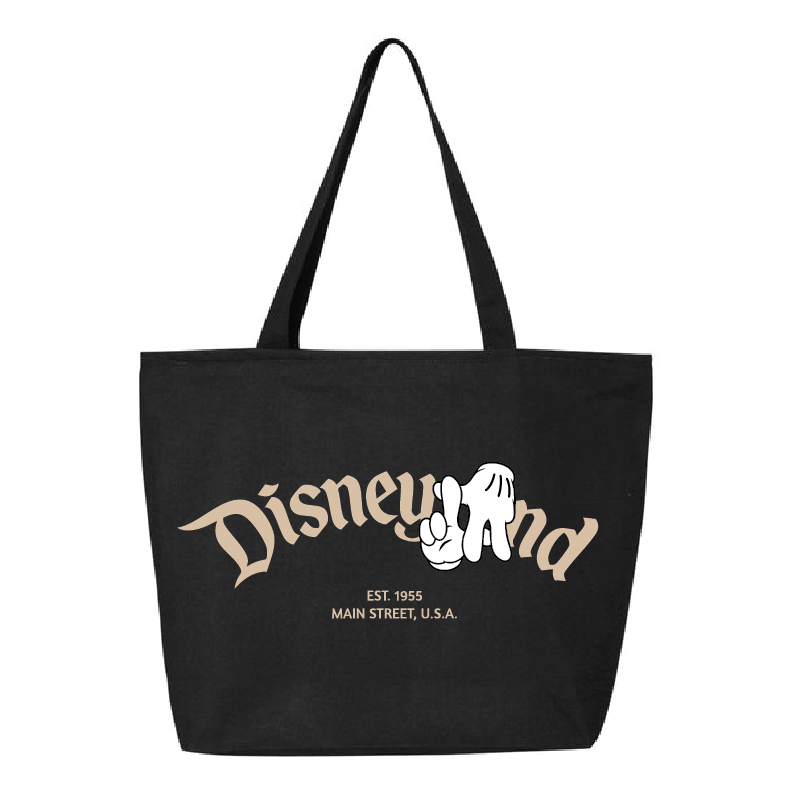 A black canvas tote bag with long shoulder straps, featuring a vintage-style beige and white 'Disneyland' graphic on the front.