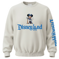 An off-white crewneck sweatshirt featuring a graphic of Minnie Mouse holding a bat above the blue text 'Disneyland' on the chest, with 'Disneyland' printed vertically in blue on the right sleeve.