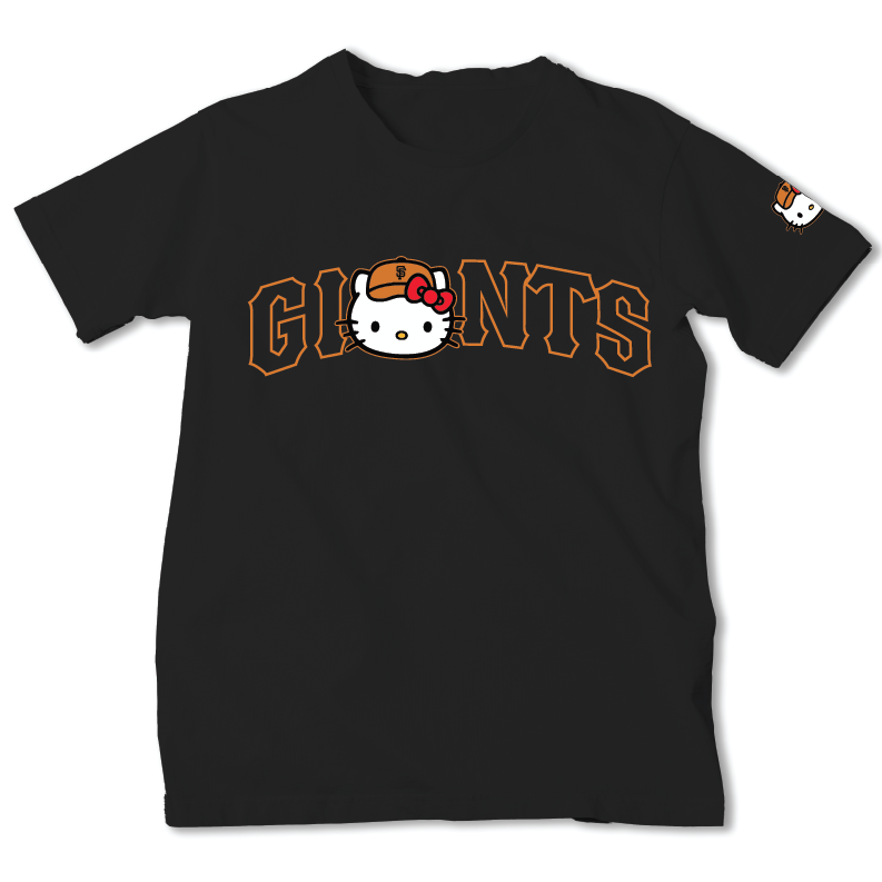 A black short-sleeve t-shirt featuring a 'GIANTS' graphic with the San Francisco Giants logo and a Hello Kitty character in the center, with a small Hello Kitty graphic on the left sleeve.