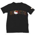 A black short-sleeve t-shirt featuring a 'GIANTS' graphic with the San Francisco Giants logo and a Hello Kitty character in the center, with a small Hello Kitty graphic on the left sleeve.