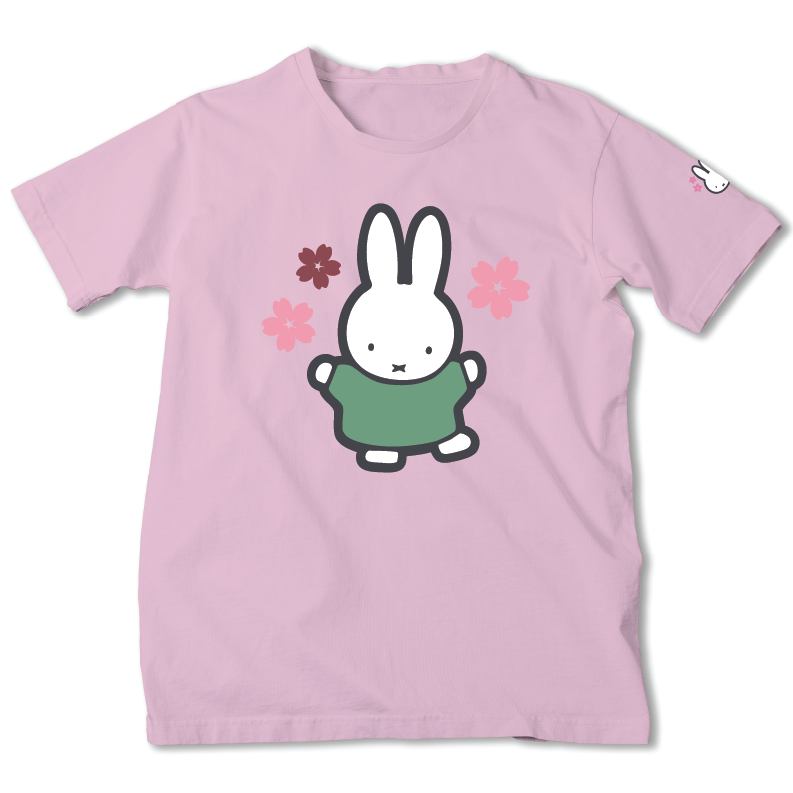A light pink short-sleeve t-shirt featuring a cartoon graphic of Miffy the rabbit wearing a green sweater, surrounded by pink and dark red flowers. A small white rabbit logo is printed on the left sleeve.
