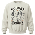 Spooky & Groovy skeleton Halloween shirt featuring dancing skeletons, stars and a crescent moon. A fun retro tee for spooky season.
